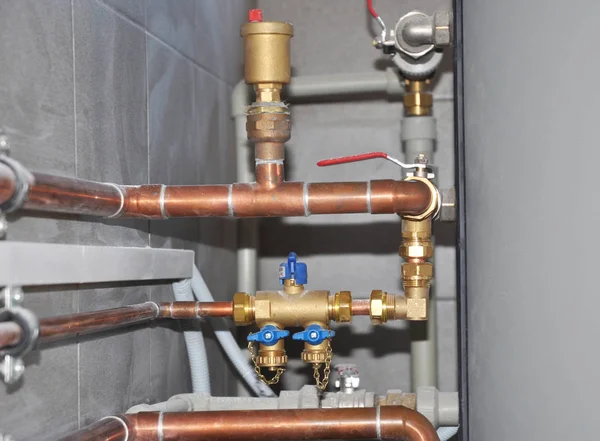 Copper pipes of solar water heater system in boiler room.