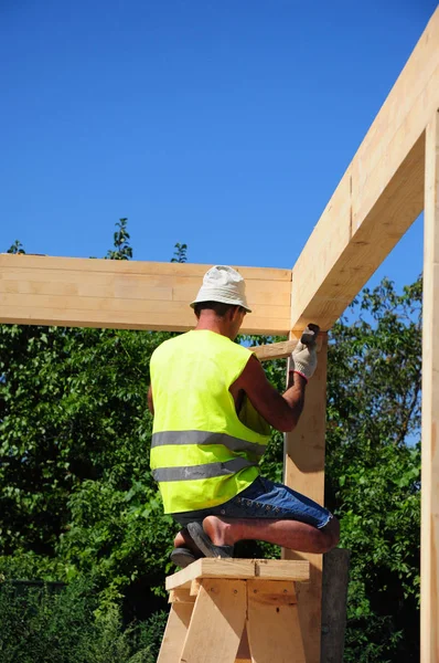 stock image Roofer install roof wooden trusses. 