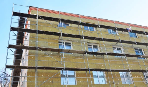 Solid wall insulation with rock wool. Energy efficiency house wall renovation for energy saving. Exterior house wall heat insulation with mineral wool. External wall insulation.