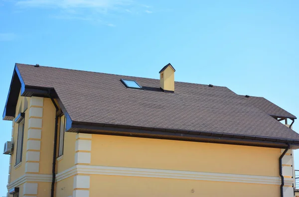 House roof with Asphalt shingles, attic skylight window.