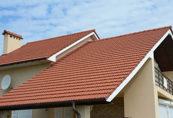 Cozy house with balcony, clay tiled roof and gable and valley type of roof construction. Building attic house construction with different types of roof designs — Stock Photo, Image