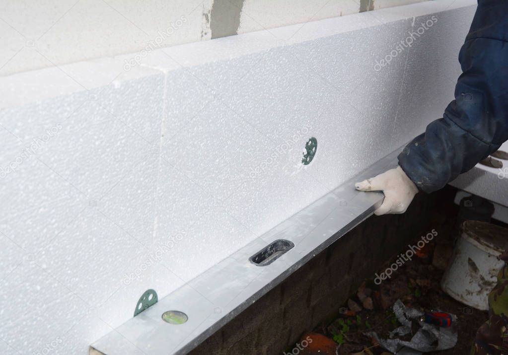 Builder install Styrofoam insulation board. House  Wall Polystyrene Insulation.  Rigid extruded polystyrene insulation.