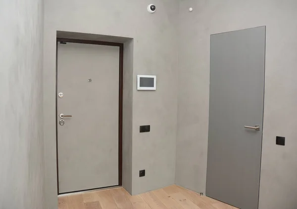 Modern house entrance metal door interior with security  CCTV camera is mounted on the room wall with fire alarm system, smart house system