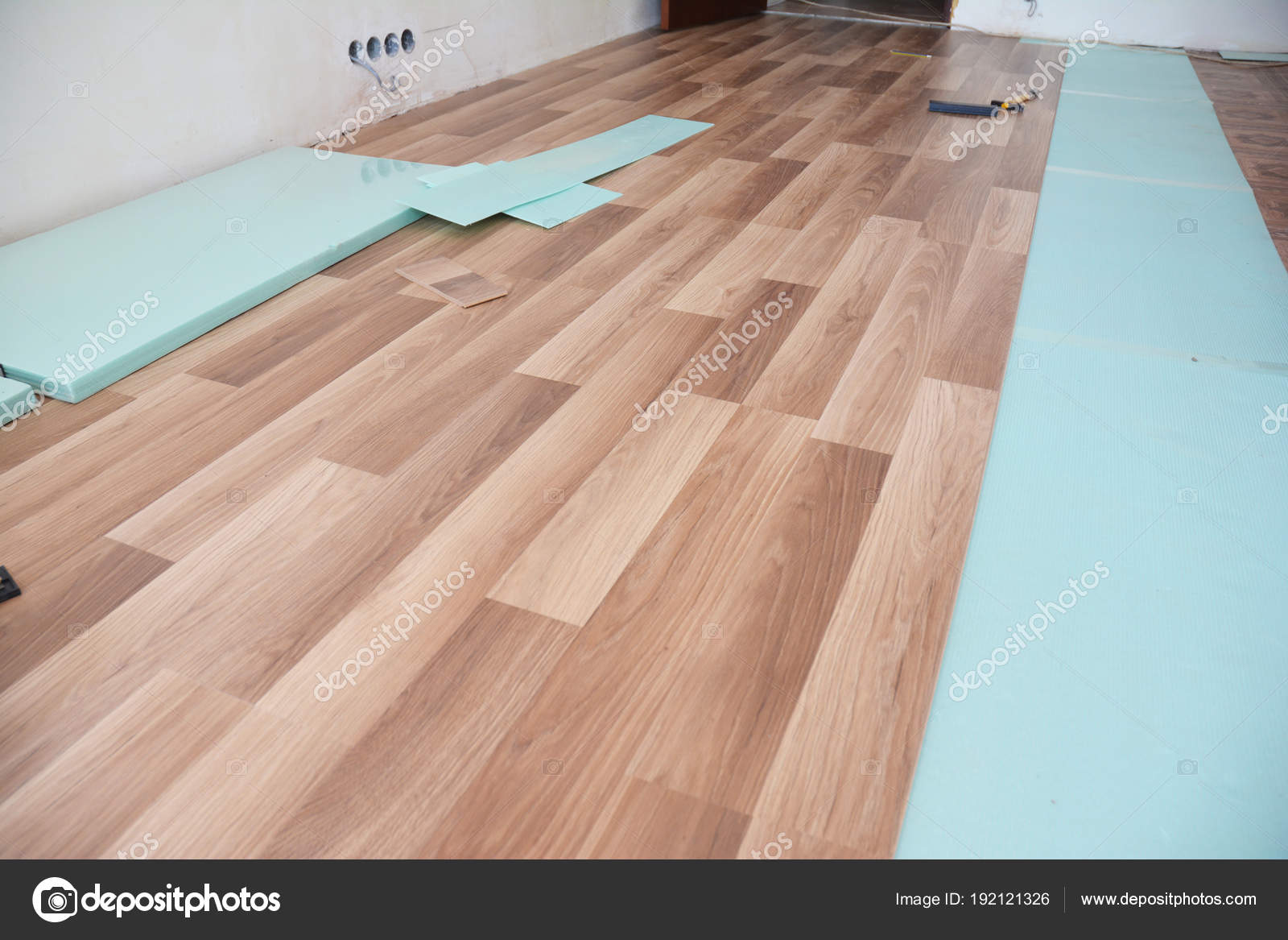 Installing Wooden Laminate Flooring With Insulation And Installing Wooden Laminate Flooring With Insulation And Soundproofing Sheets Stock Photo