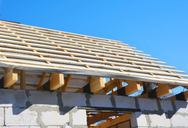 Evin çatı inşaat panorama. Su geçirmez maddeler, ahşap kirişleri, saçak, yükleme bitüm ve kereste ile günlüğe kaydeder.