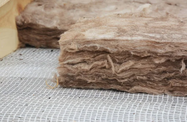 Roof Insulation. Close up on insulation layers of mineral wool insulation, house roof insulation.