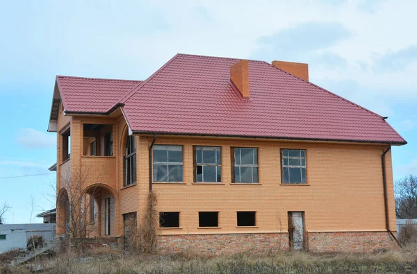 Construção de nova casa de tijolo com telhado de chapas de aço — Fotografia de Stock