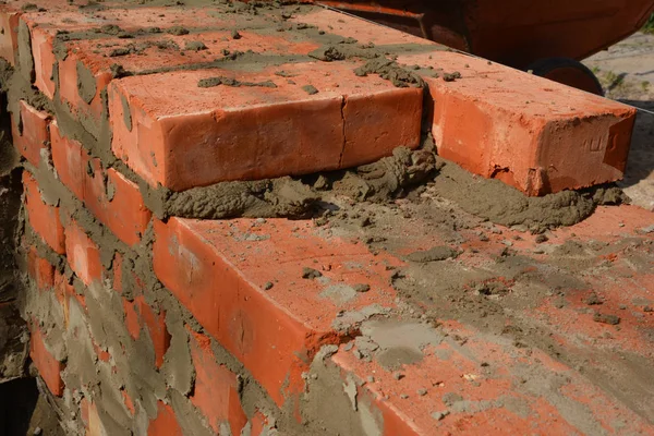 Close up on laying bricks. Building brick wall — 图库照片