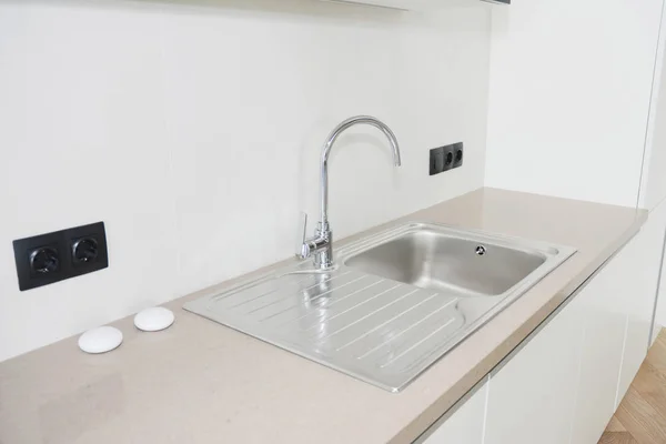 Modern kitchen metal faucet and  kitchen sink. Stock Image