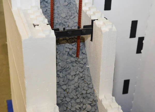 A close-up on insulating concrete forms ICF, cast-in-place concrete walls that are sandwiched between two layers of insulation polystyrene foam material for residential and industrial constructions.