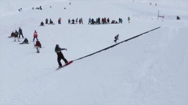 Sochi, Rusya Federasyonu - 31 Mart 2016: Snowboard yapmak sıçrama tahtası, slayt üzerinde yamaçta demir iz binmek. Manzara. Karlı dağlar.
