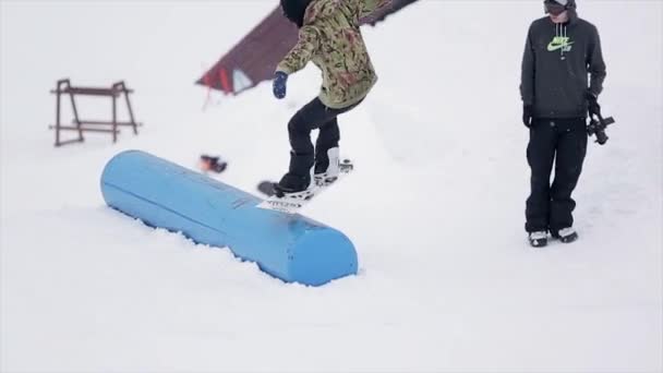 SOCHI, RUSSIA - MARCH 29, 2016: Snowboarder jump on kicker at ski resort in mountains. Extreme sport. People. Springboard. Challenge — Stock Video