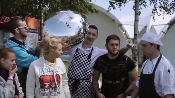 SAN PETERSBURG, RUSIA - 16 DE JULIO DE 2015: Personas posando en cámara con globo aerostático de cristal. Cocineros. Festival de verano. Día soleado. Vacaciones — Vídeo de stock