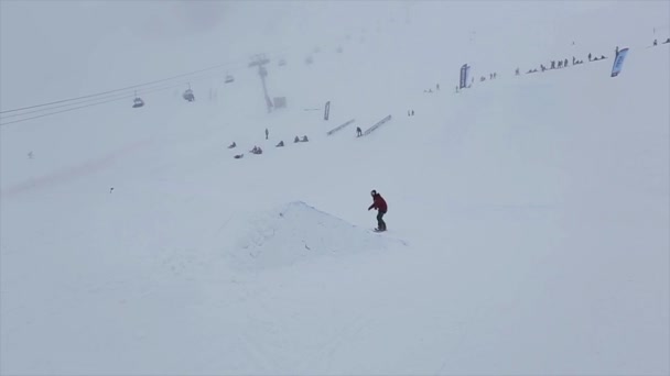SOCHI, RÚSSIA - MARÇO 29, 2016: Snowboarder jump from springboard at slope, flip in air. Estância de esqui em montanhas nevadas. Desafio . — Vídeo de Stock