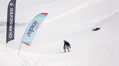 Sochi, Rusya Federasyonu - 1 Nisan 2016: Snowboarder yüksek atlama sıçrama tahtası üzerinden yapmak, havada arkanı dön. Kayak Merkezi