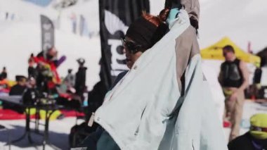 Sochi, Rusya Federasyonu - 2 Nisan 2016: Güneş gözlüğü gülümseme kamera içinde kız encamp diğer insanlar arasında. Kayak Merkezi.