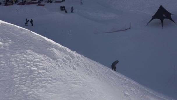 SOCHI, RUSSIA - APRIL 2, 2016: Snowboarder slide down on snowy slope. Sunny day. Ski resort. People. Extreme — Stock Video