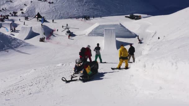 索契，俄罗斯-2016 年 4 月 1 日︰ 滑雪板骑在雪地滑雪胜地在雪山在阳光明媚的日子。斜坡。跳板 — 图库视频影像