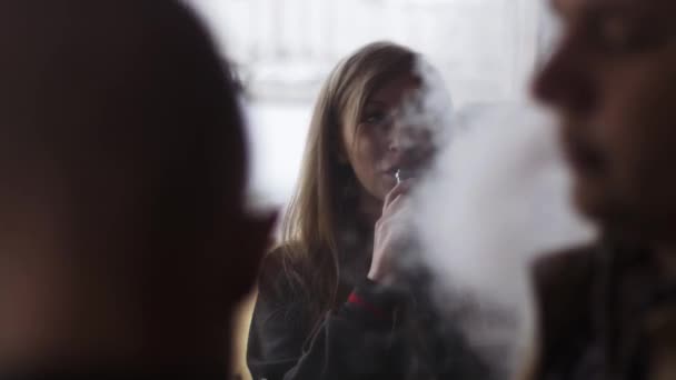Blond flicka utandning ånga från elektronisk cigarett. Festival av vejpare. — Stockvideo