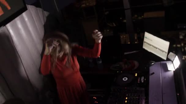 Sint-Petersburg, Rusland - 17 juni 2016: Dj meisje in de rode jurk sprong op de draaitafel op party in discotheek. Hoofdtelefoon. Dans — Stockvideo