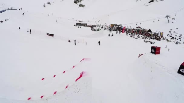 SOCHI, RUSIA - 4 DE ABRIL DE 2016: Quadrocopter disparar snowboarder salto desde el trampolín, agarrar el tablero en el aire. Fallar — Vídeos de Stock