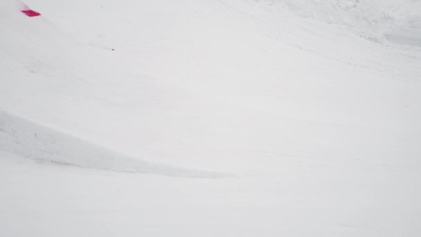 Sochi, Rusland - 4 April 2016: Snowboarder make hoogspringen van de Springplank. Skigebied. Landschap, bergen. — Stockvideo