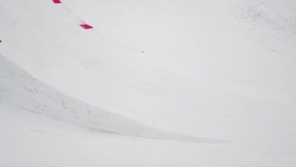 Sotschi, Russland - 4. April 2016: Snowboarder springt vom Sprungbrett, überschlägt sich in der Luft. Skigebiet. Landschaft. — Stockvideo