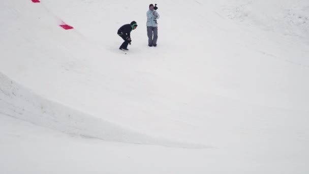 SOCHI, RUSSIE - 4 AVRIL 2016 : Le skieur saute du tremplin, se retourne dans l'air avec les pieds croisés. Station de ski . — Video