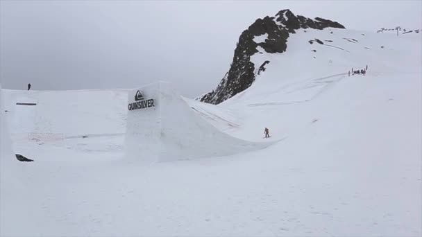 Sochi, Rusland - 4 April 2016: Skiër sprong van de Springplank, maken flip in lucht. Uithangbord. Grijze weer. Berg — Stockvideo