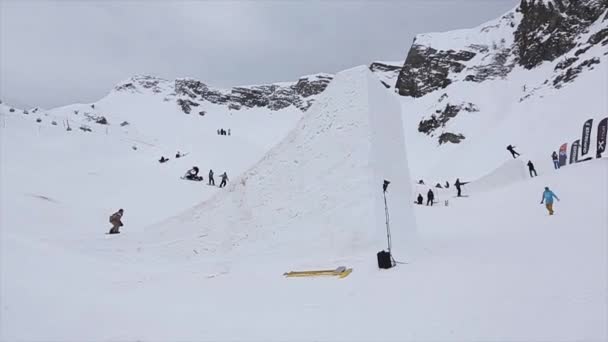 СОЧИ, РОССИЯ - 4 апреля 2016 года: прыжок сноубордиста с трамплина на горнолыжном курорте. Делай. Сомневайся . — стоковое видео