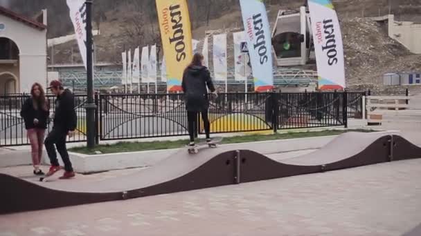 SOCHI, RUSSIA - APRIL 4, 2016: Skateboarder rolls on springboards on street in city. People. Teenager. Practice — Stock Video