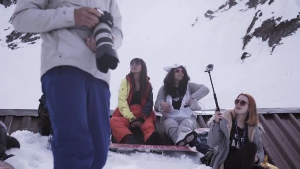 SOCHI, RUSIA - 1 DE ABRIL DE 2016: Estación de esquí. Chicas jóvenes en el campamento. Descansando. Montañas. Camarógrafo. Gafas de sol — Vídeos de Stock