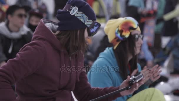 俄罗斯索契-2016 年 4 月 1 日︰ 滑雪胜地。滑雪板和滑雪者在扎营。女孩鼓掌。衣服。太阳镜 — 图库视频影像