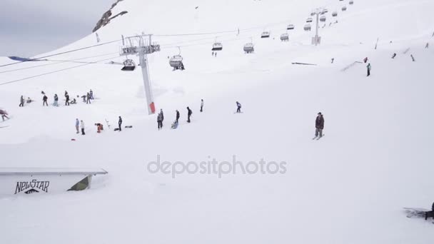 SOCHI, RUSSIA - APRIL 1, 2016: Ski resort. Skier slide on trail, failing. People. Snow mountains. Extreme sport — Stock Video
