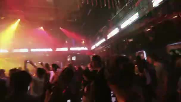SOCHI, RUSSIA - APRIL 8, 2016: People dancing on party in nightclub. Spotlights. Laser show. Young girl. Cheer — Stock Video