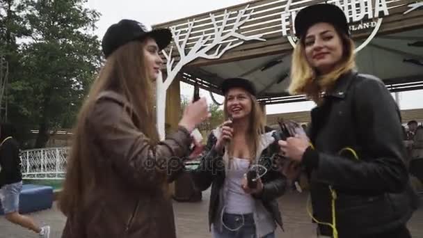 SAINT PETERSBURG, RÚSSIA - 28 de maio de 2016: Meninas com lábios vermelhos e cigarro eletrônico de fumo de boné na rua. Festival Vaper — Vídeo de Stock