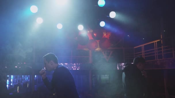 Saint petersburg, russland - 28. Mai 2016: Männer atmen in einem Nachtclub Dampf aus einer elektronischen Zigarette aus. Herausforderung. Scheinwerfer — Stockvideo