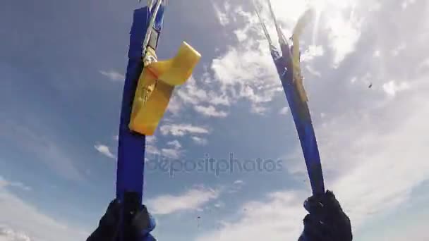 Skydiver opens parachute in sky above green fields. Extreme. Adrenaline. Clouds — Stock Video
