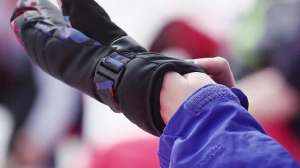 SOCHI, RÚSSIA - 7 de abril de 2016: Menina de uniforme de esqui vestida de luva preta em estância de esqui. Evento desportivo. Acampamento — Vídeo de Stock