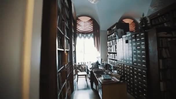 Tracking shot old style archive interior. Bookshelves. curtains, printer — Stock Video