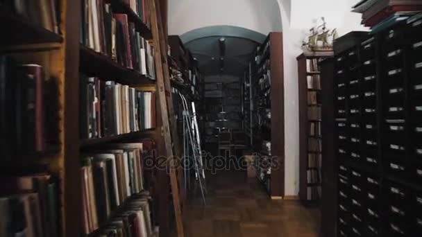 Tracking shot old style library interior. Wooden floor. bookshelves archives — Stock Video