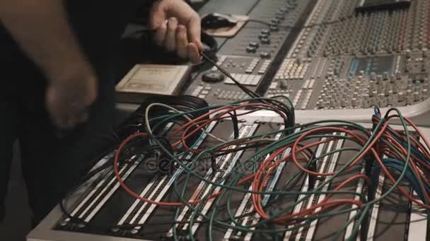 Close up man hands pulling lot of wires on music mixing console — Stock Video