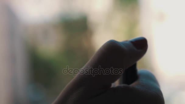 Slowmotion close up of woman palm with nail painted red flaming up a lighter — Stock Video