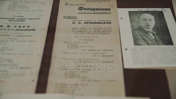 SAINT PETERSBURG, RUSSIA - JUNE 23, 2016: Dolly shot close up old russian music pamphlets and black and white photographs — Stock Video