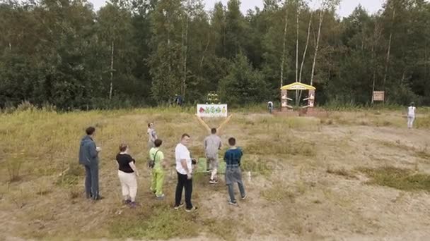 СЕНТ-ПЕТЕРБУРГ, РОССИЯ - 30 июля 2016 года: Люди, стреляющие с воздуха, играют в злобных птиц с плюшевой и гигантской рогаткой снаружи — стоковое видео
