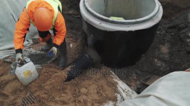 Saint Petersburg, Rusya Federasyonu - 26 Eylül 2016: Turuncu zor şapka işçi sıvı çimento dökmek ve spatula ile ikna edeceğim