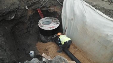 Saint Petersburg, Rusya - 26 Eylül 2016: Kask tak siyah plastik boru beton kuyu Ring hendekte Builder'da