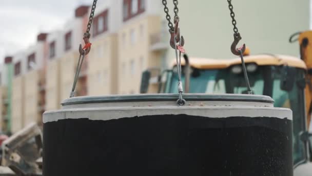 Concrete chamber manhole ring stuck on rings pulling down at building site — Stock Video