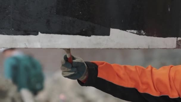 Worker hand brush bottom of concrete chamber manhole ring haiging in air — Stock Video