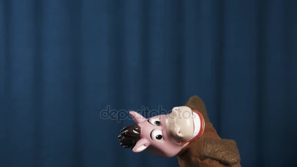 Horse hand puppet makes vivid scene exit and run away with blue background — Stock Video